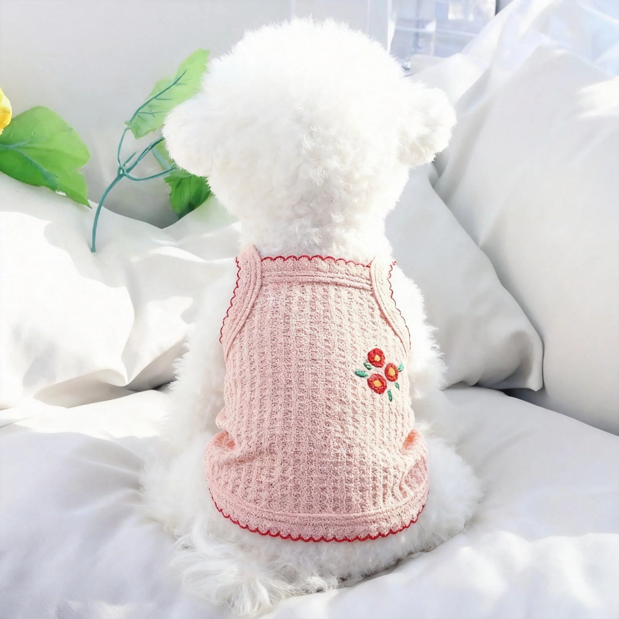 Small dog wearing a soft, breathable pink floral tank top, perfect for cool summer comfort for Bichons and Yorkies.