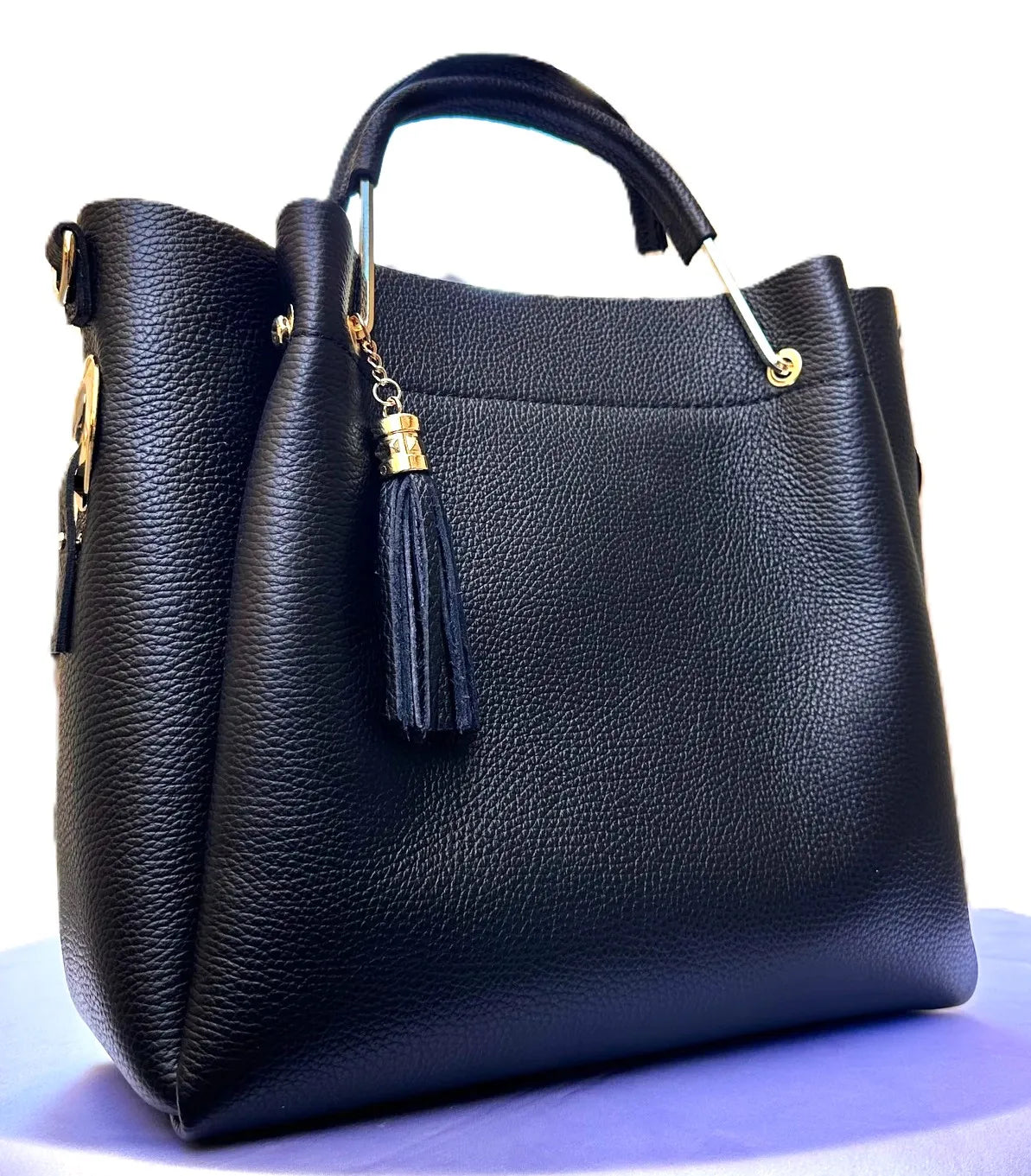 Royaa large black designer tote bag in pebbled genuine leather with gold hardware, single handle, and leather tassel.