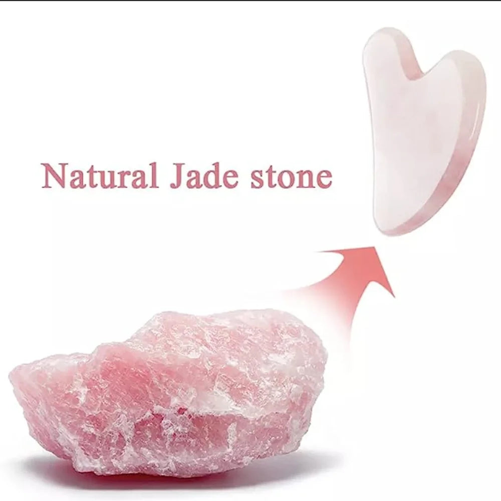 A raw piece of pink rose quartz beside a polished, heart-shaped gua sha massage tool on a white background.