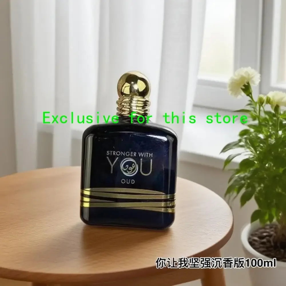 Stronger With You Oud 100ml: Unisex long-lasting EDP in a dark blue bottle with gold accents. Rich woody fragrance.