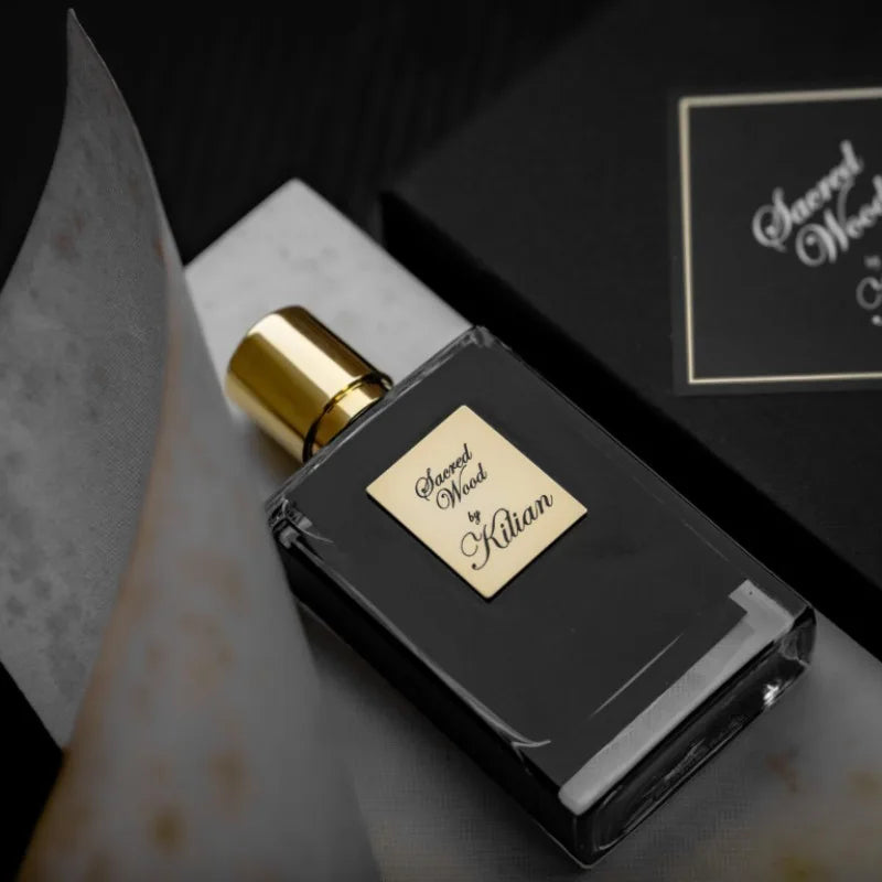 Kilian Sacred Wood unisex EDP 50ml: black rectangular bottle, woody spicy niche fragrance with a gold cap and label.