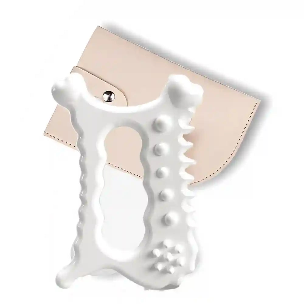 White ceramic Gua sha massage tool with bumpy textured edges and a center hole, displayed with a beige storage case.
