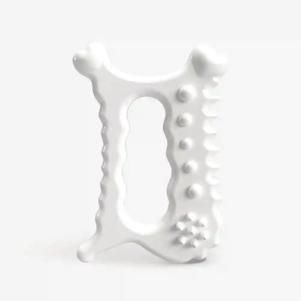 White ceramic gua sha facial tool with a central handle, textured edges, and rounded massage nodules.