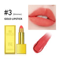 Gold brick case shimmering coral pink lipstick with glitter texture, shown on lips and as a swatch.