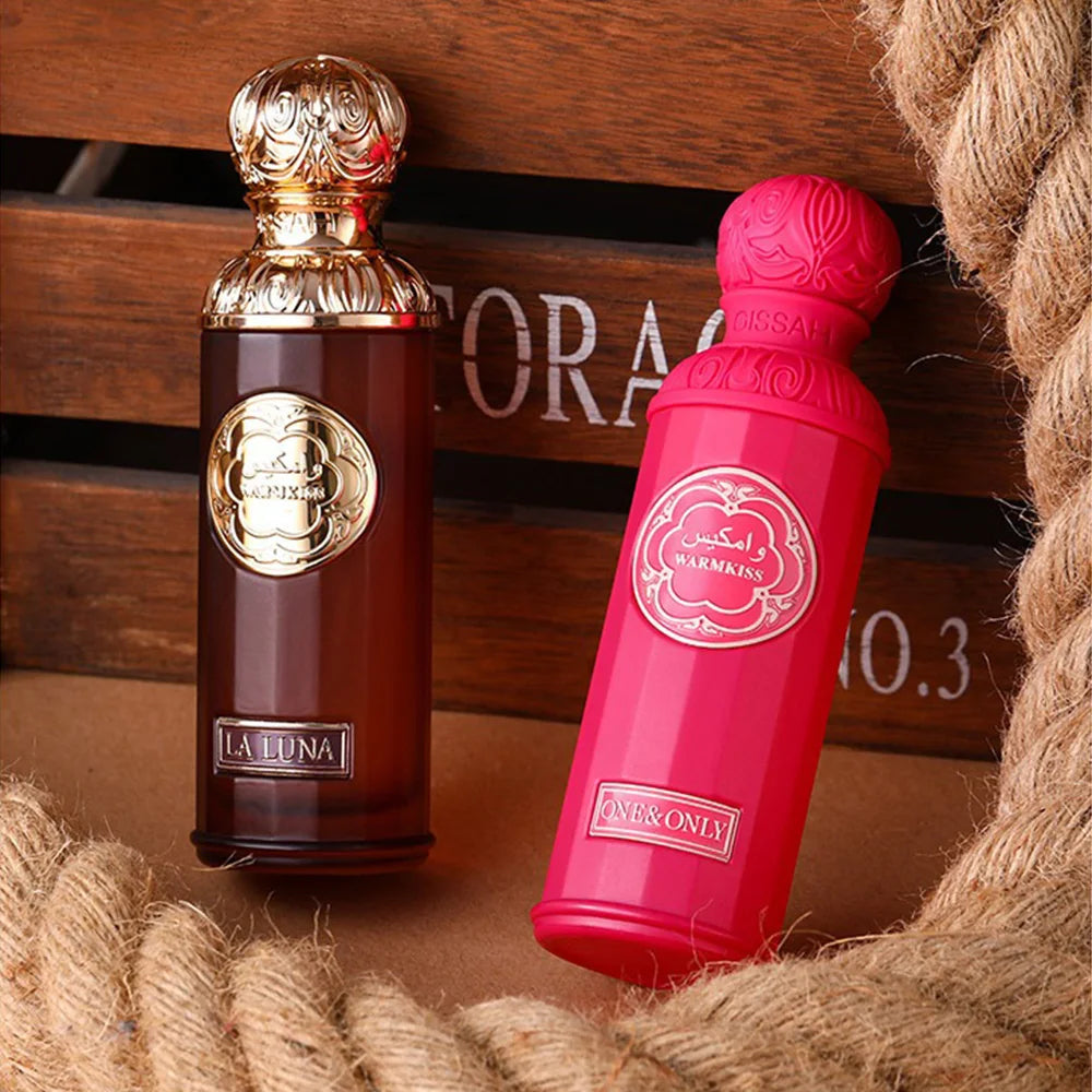 Gissah La Luna & Warmkiss unisex EDP: Luxury Middle Eastern 100ml perfume bottles with gold and pink ornate caps.
