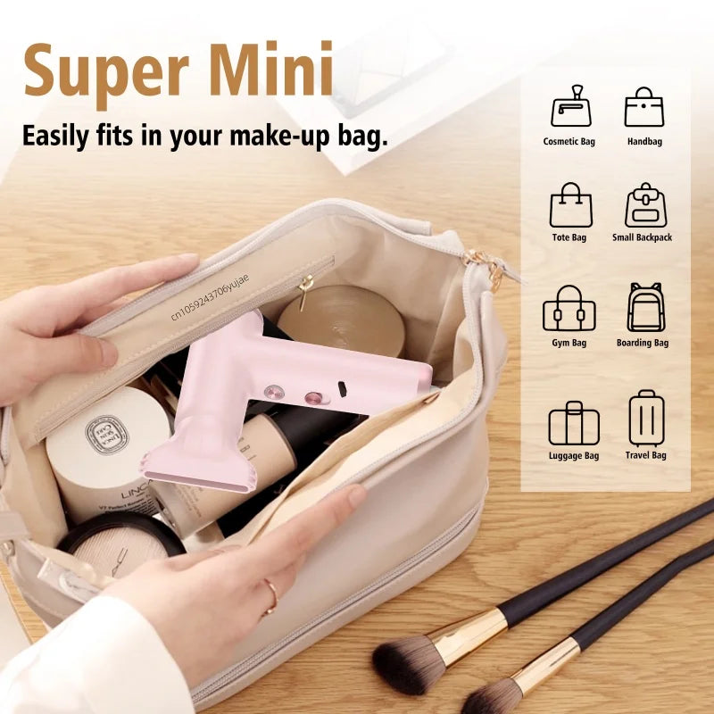 Pink mini high-speed travel hair dryer with magnetic nozzle, fitting perfectly inside a cosmetic bag for portability.