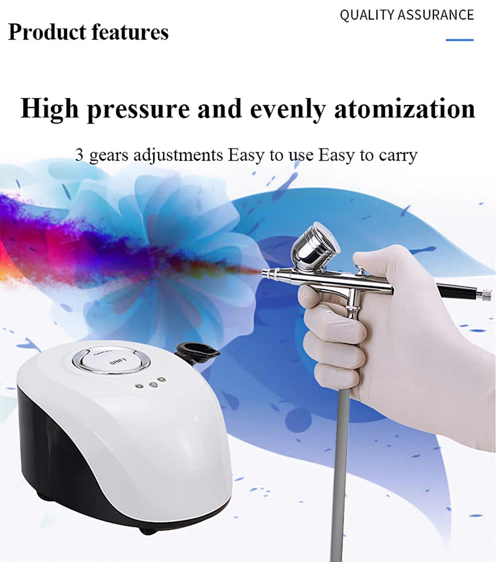 Hand holding a chrome airbrush connected to a sleek, white and black portable air compressor machine.
