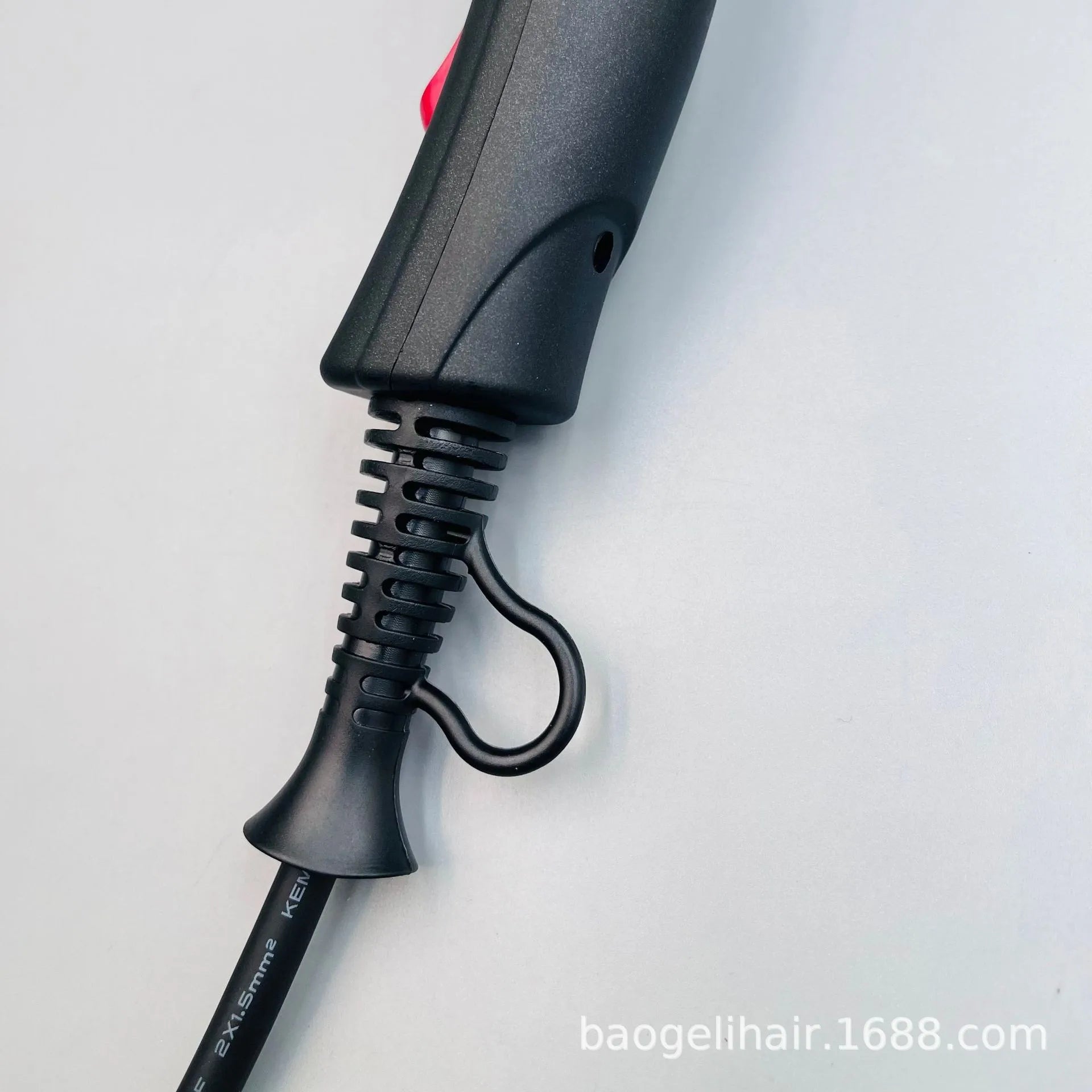 Black 2600W salon hair dryer handle detail featuring a durable power cord with a convenient hanging loop for storage.