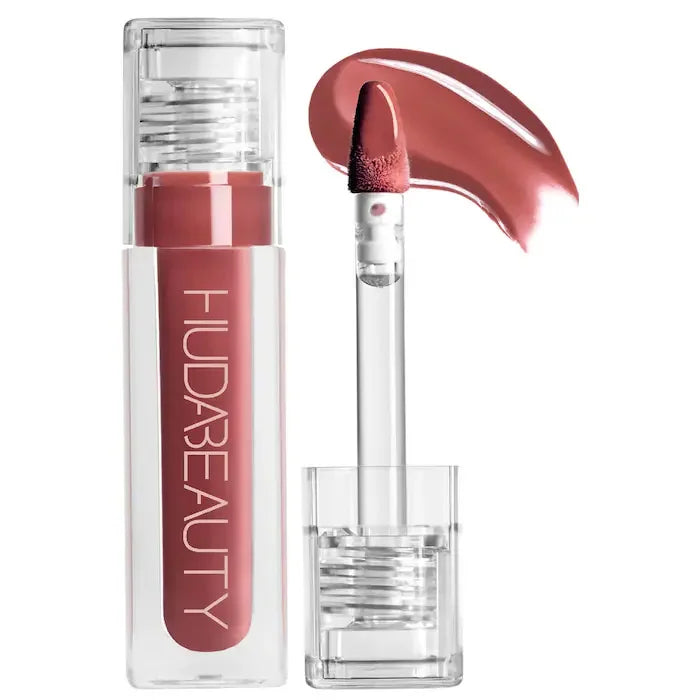 Huda Beauty hydrating lip and cheek tint in a dusty rose shade with applicator wand and cream swatch.