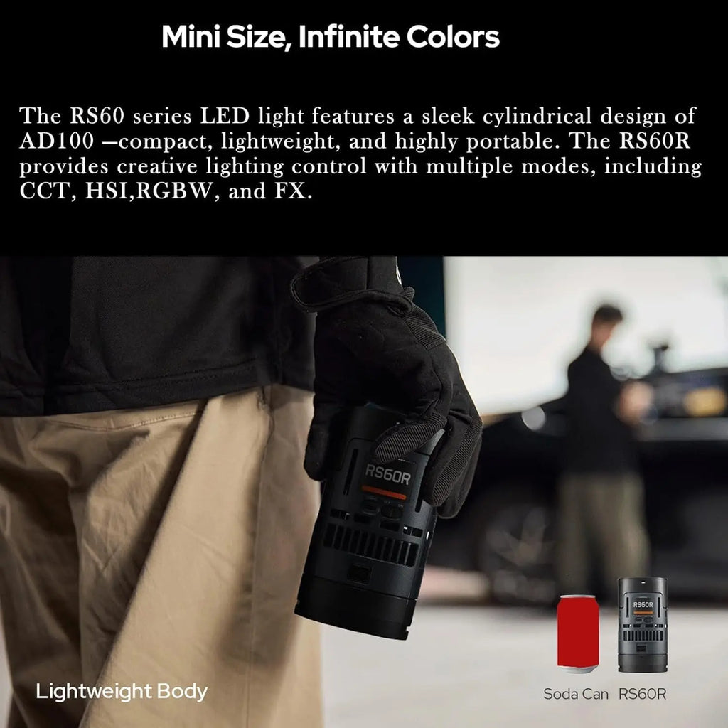 Black cylindrical RS60R LED light, similar in size to a soda can, held in a gloved hand for portable creative lighting.