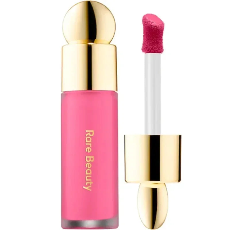Rare Beauty matte lipstick in rich pink with gold cap, smooth applicator, and moisturizing liquid lip makeup texture.