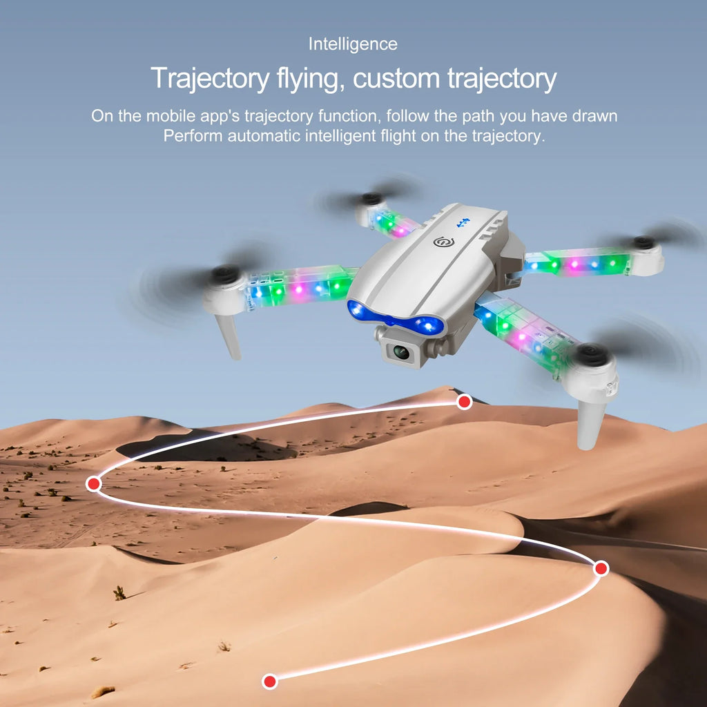 Silver quadcopter drone with colorful LED lights flying over a desert, following a digital flight path.