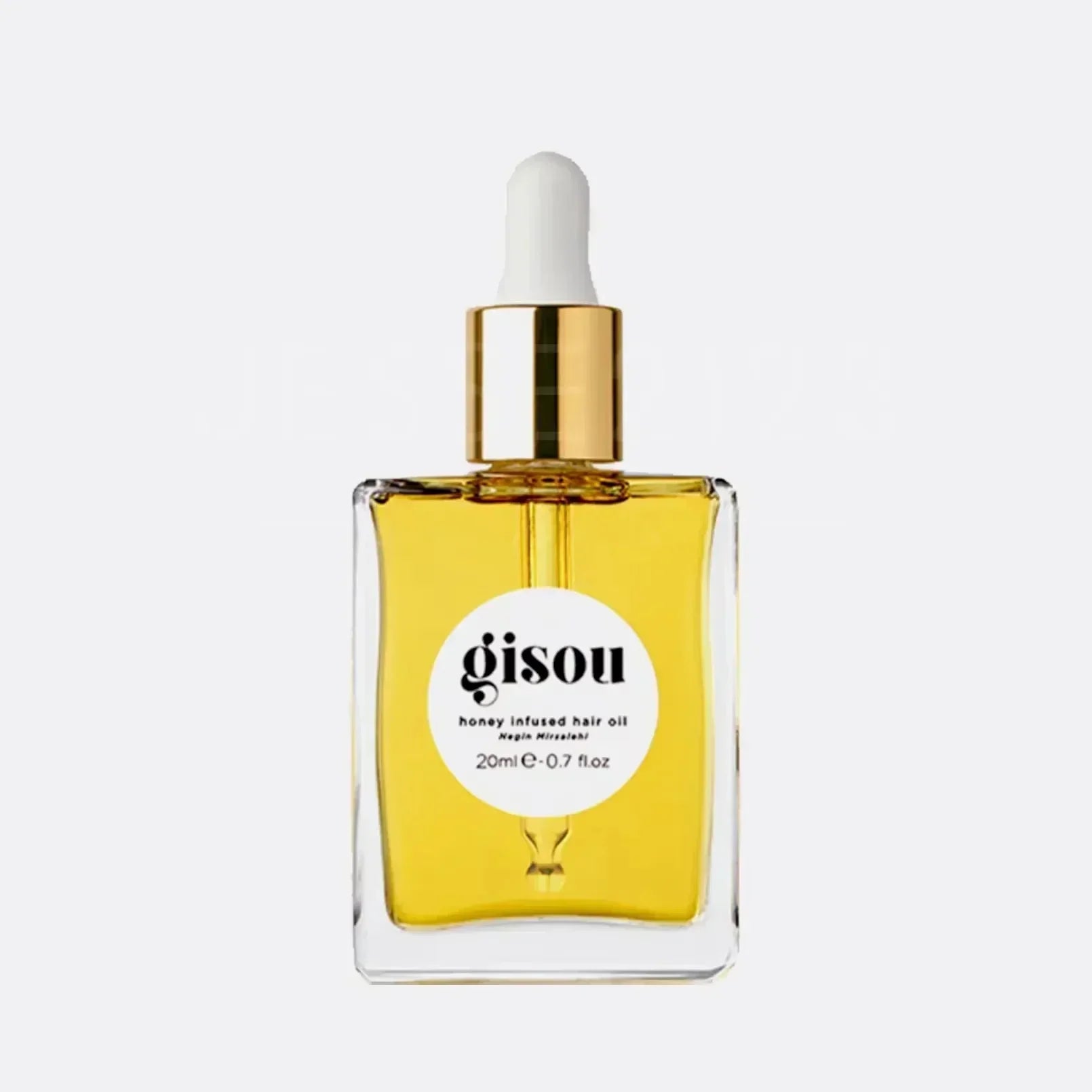 Gisou honey-infused moisturizing lip oil in a square glass bottle with gold dropper, golden liquid texture.