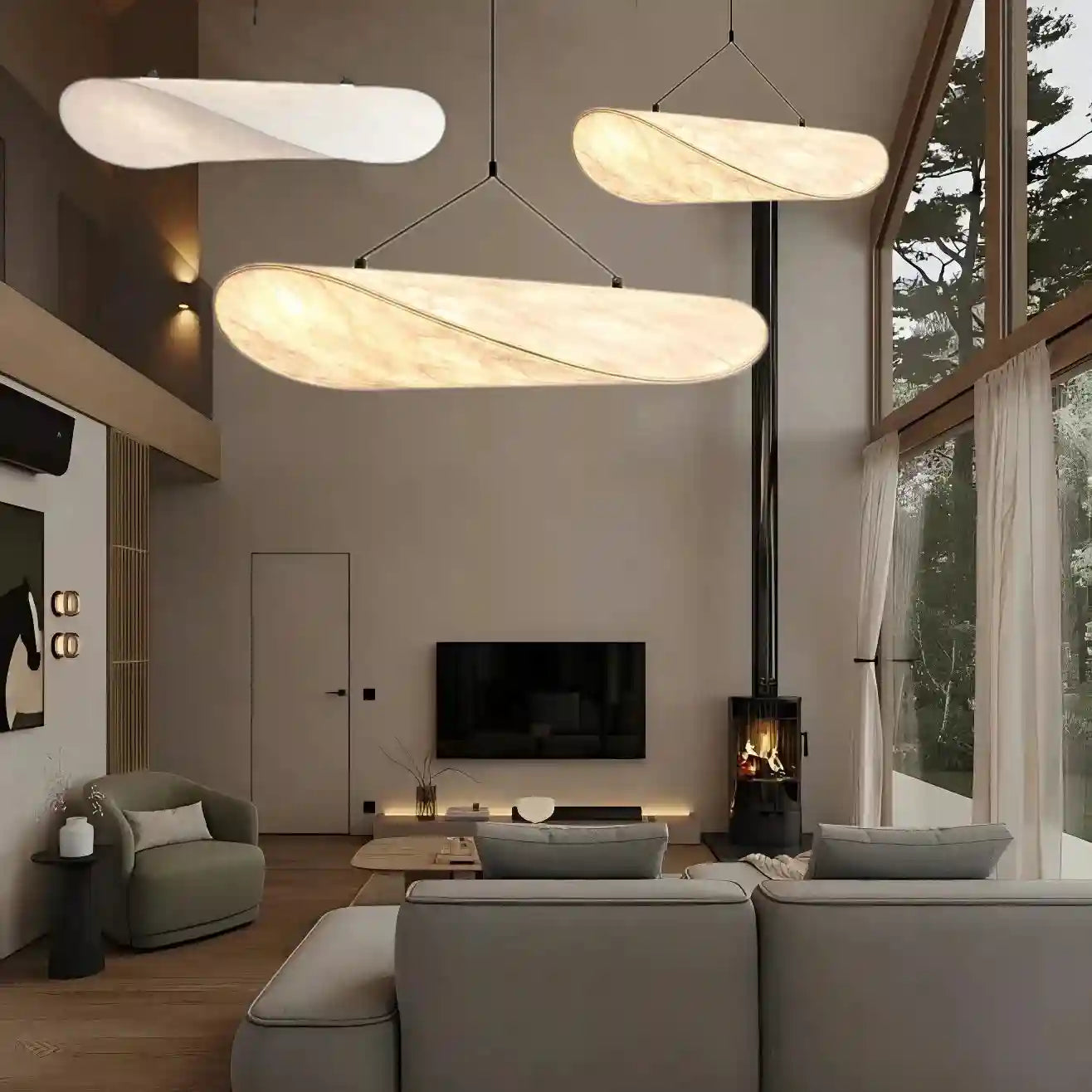 Long, curved pendant lights with marbled fabric shades, suspended by thin wires for ambient indoor lighting.