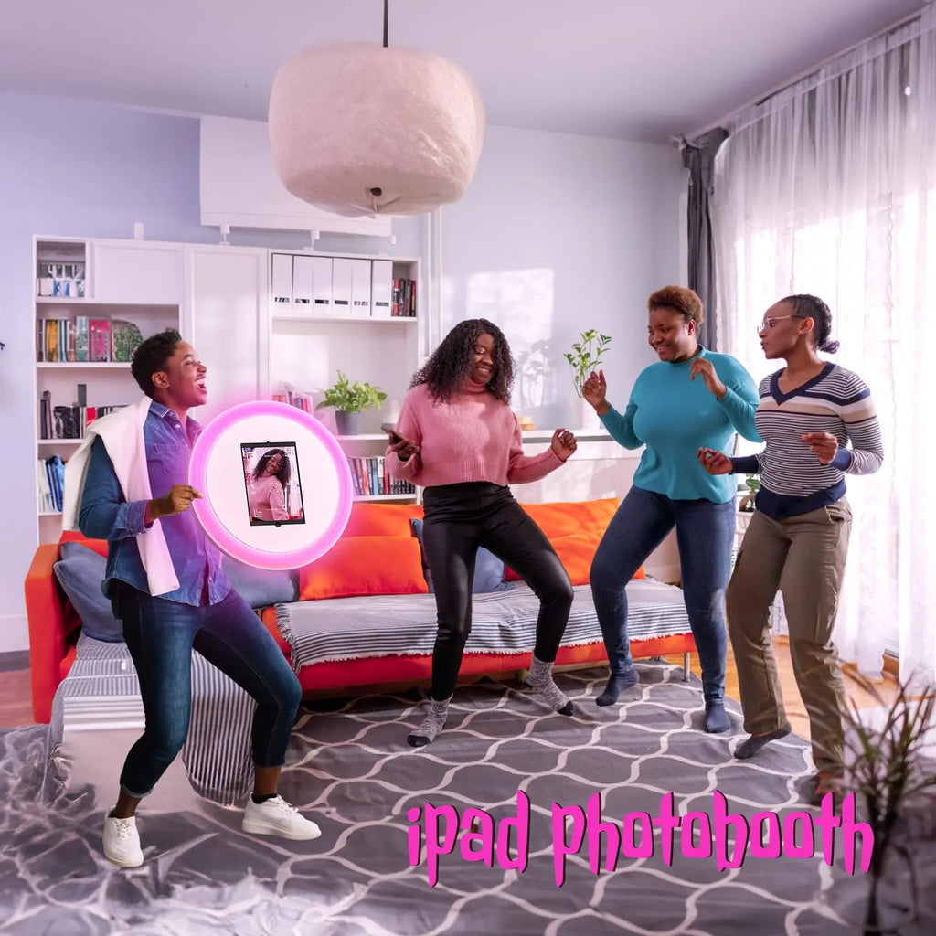 Round iPad photo booth with a glowing pink LED ring light, mounted on a stand for social events and parties.