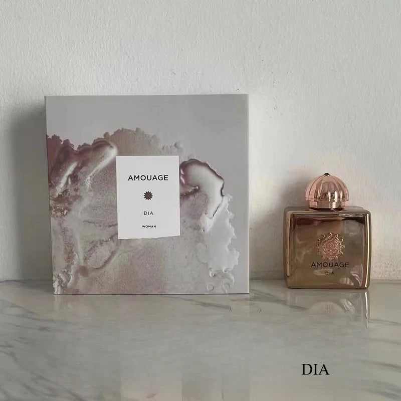 Amouage Dia Woman 100ml EDP: Luxury floral woody musk perfume in a square metallic gold bottle with artistic gift box.