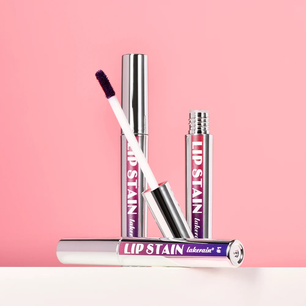Waterproof peel-off lip stain with wand applicator in silver tubes against a pink background for matte, transfer-proof lip.