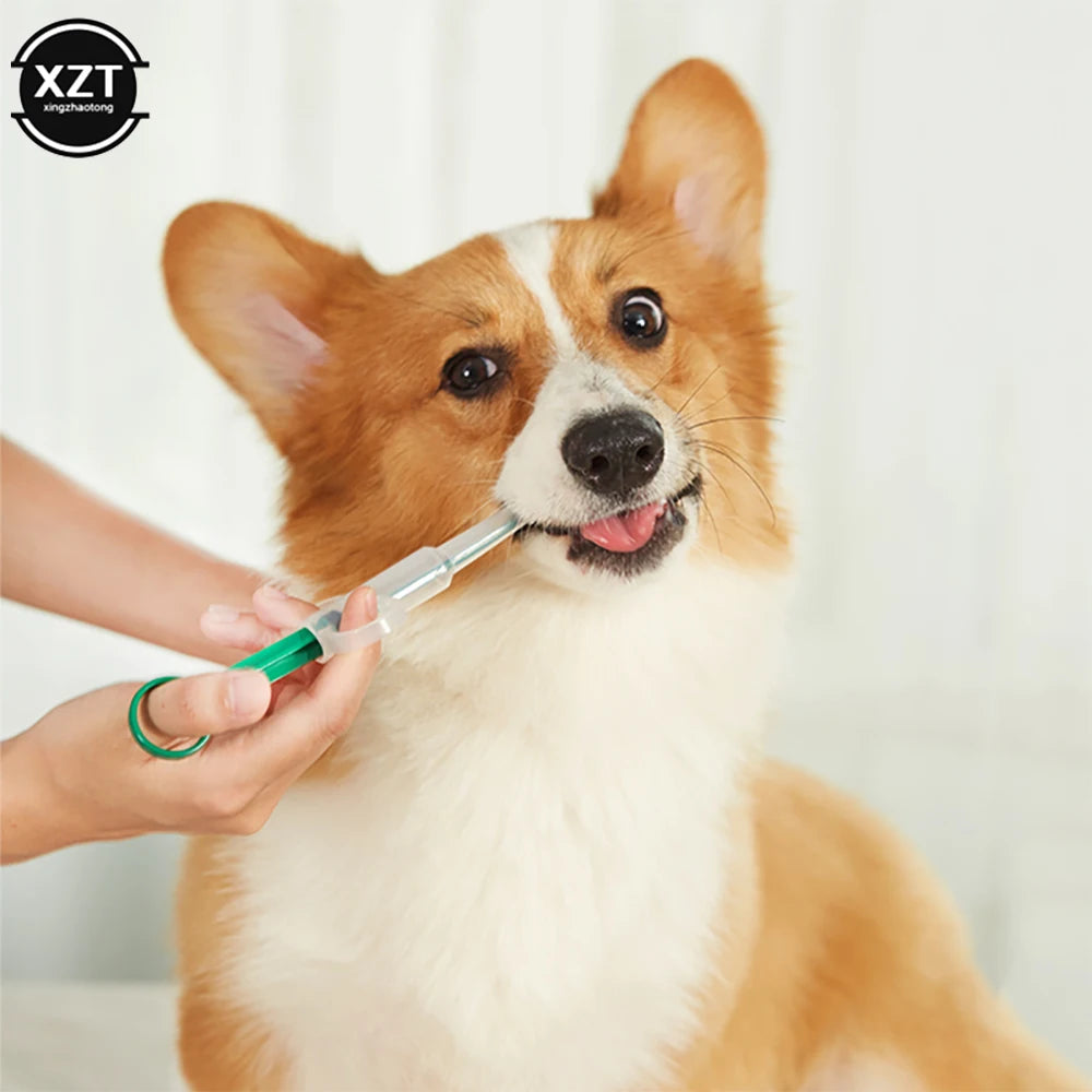 Green plastic pet pill dispenser syringe feeding medicine to a Corgi dog for easy, stress-free medication.