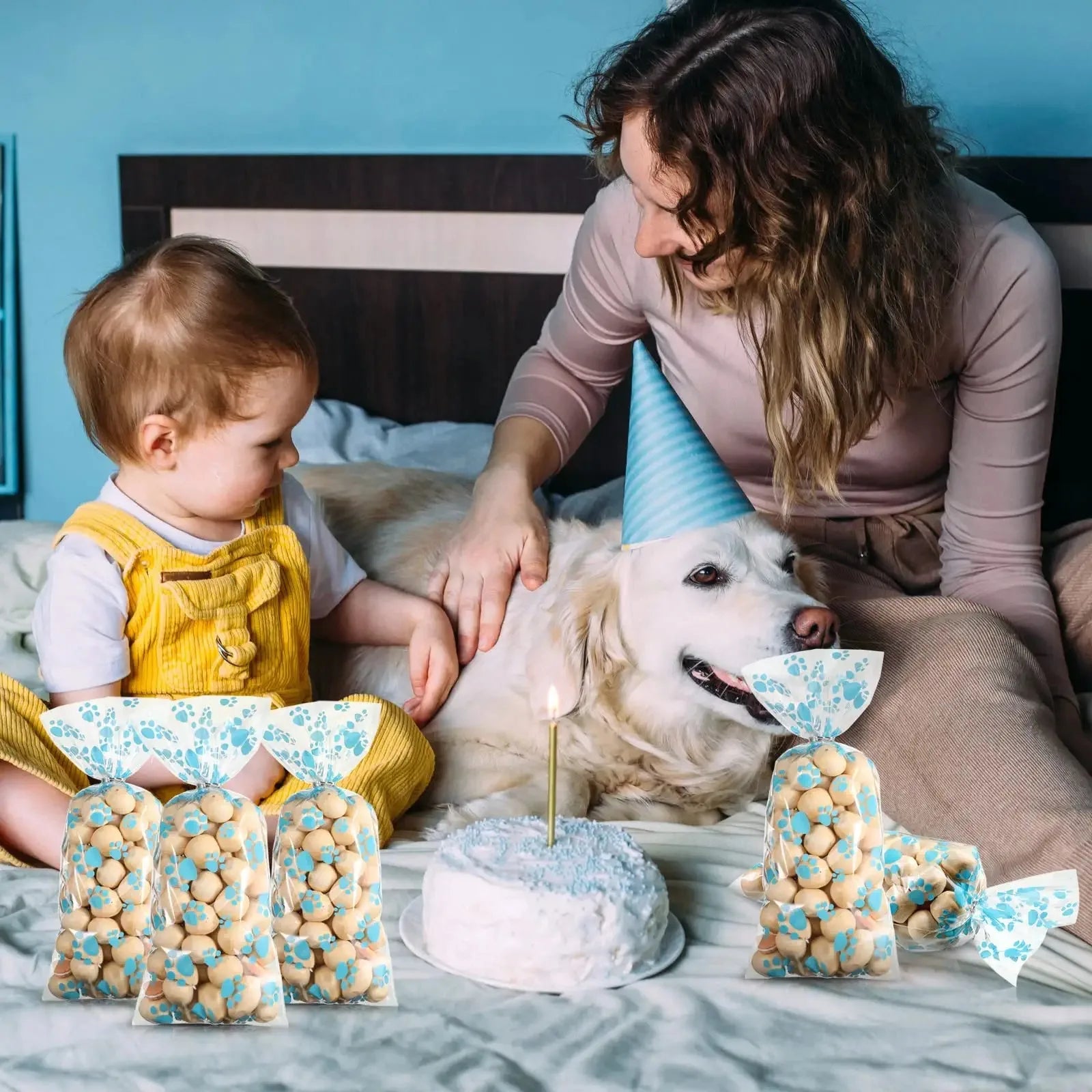 Clear cellophane treat bags with blue paw prints, perfect for dog birthday party favors and pet candy gifts.
