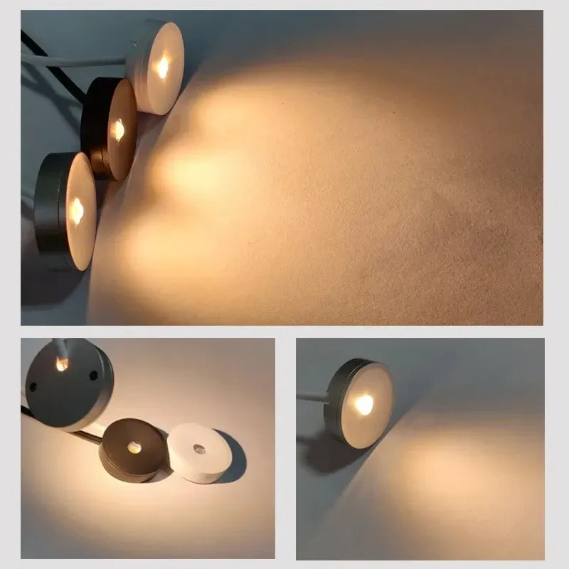 Ultra-flat recessed LED puck lights on wall corner, multiple round fixtures with lit bulbs