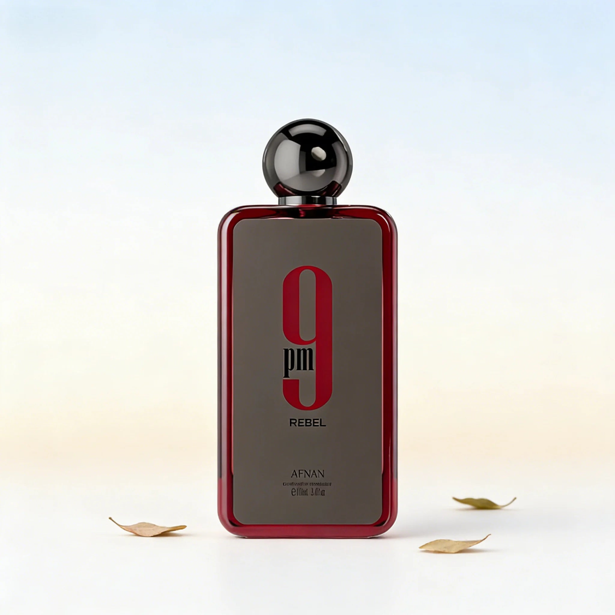Afnan 9pm Rebel EDP for men: 3.4oz woody oud fragrance in a sleek, rectangular red glass bottle with a round cap.