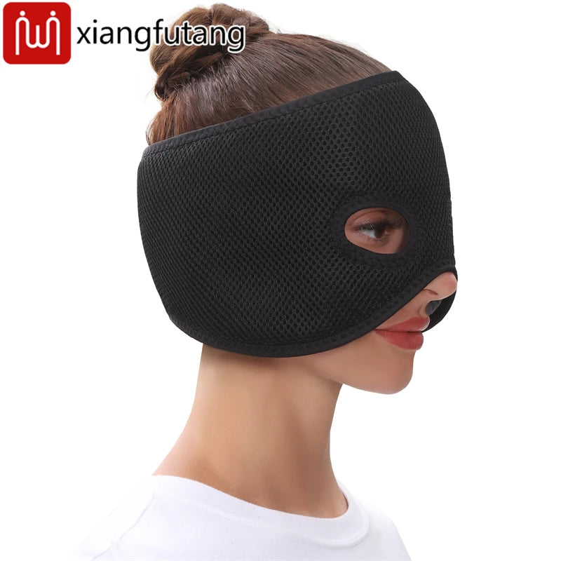 A person wearing a black, mesh-textured, half-face heating mask that covers the forehead and cheeks, leaving eyes free.