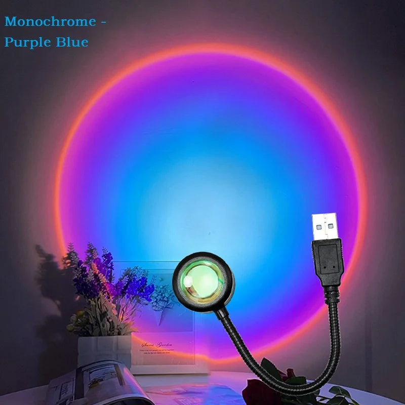 Sunset projection lamp with a flexible USB neck, casting a circular purple and blue light on a wall.