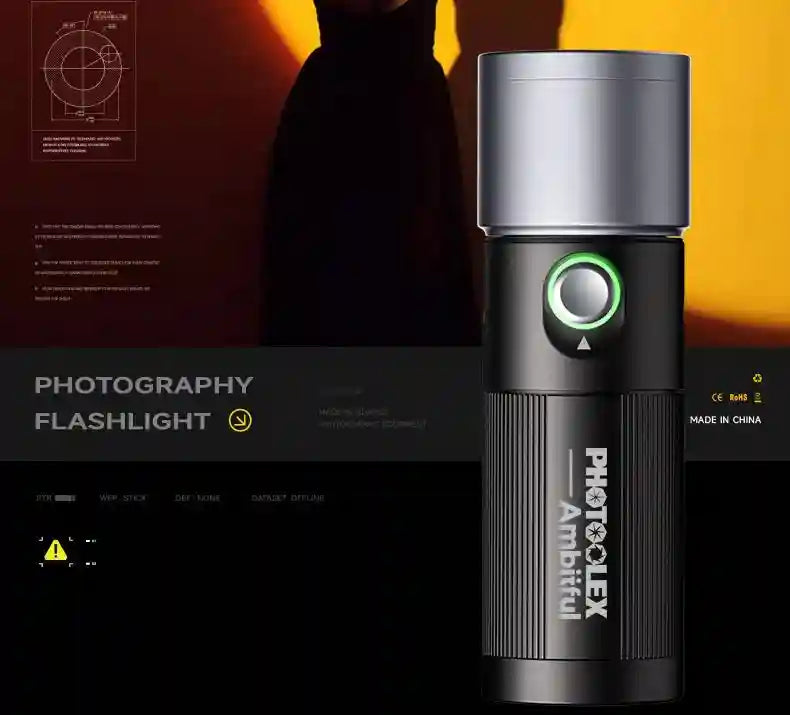 Cylindrical handheld LED photography flashlight with a matte black metal body, silver head, and green-lit power button.