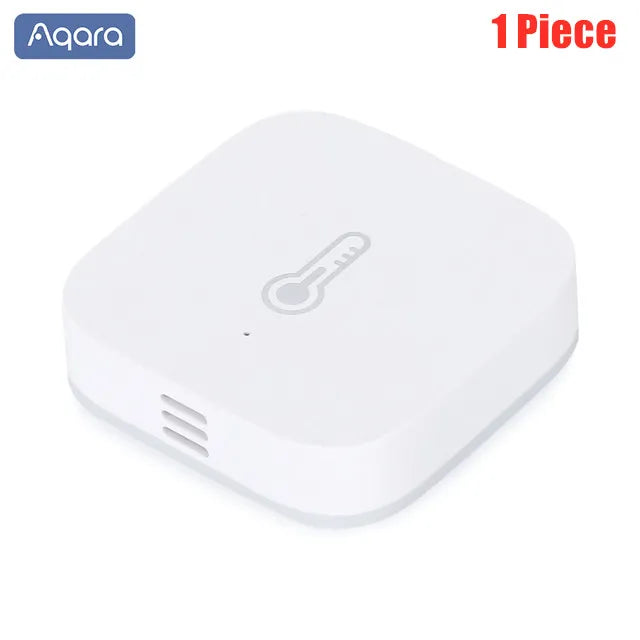Small square white Aqara smart temperature and humidity sensor with a thermometer icon and side vent slots.