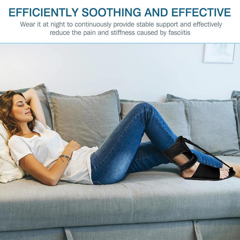 Woman relaxing on a sofa wearing a black plantar fasciitis night splint brace with adjustable straps for foot support.