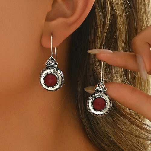 Tidesmit retro silver drop earrings featuring circular frames with intricate patterns and inlaid round deep red stones.