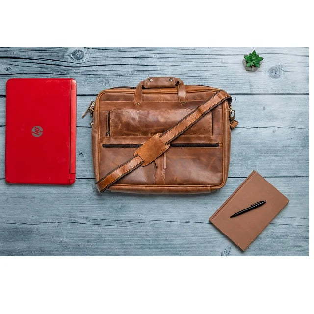 Tan genuine leather business briefcase with shoulder strap, exterior pockets, and top handles. Designer laptop bag.