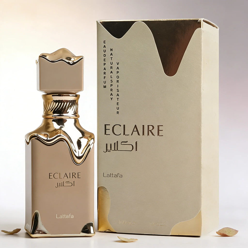 Lattafa Eclaire perfume bottle and box with metallic gold drip design, elegant beige finish, and floral scent aesthetic.