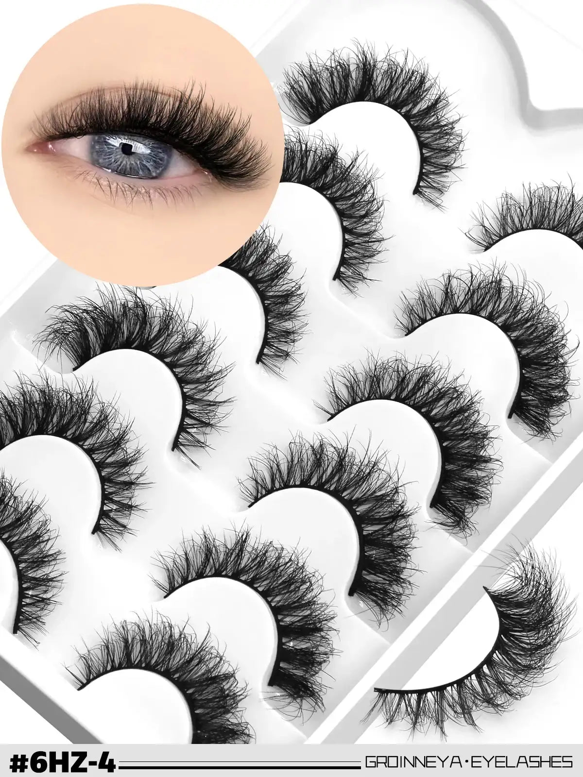 Pack of black, fluffy 3D mink false lashes with a wispy cat-eye effect and flexible band, shown on an eye and in tray.