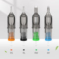 Four clear plastic tattoo needle cartridges with orange, black, green, and blue internal color-coded bases.