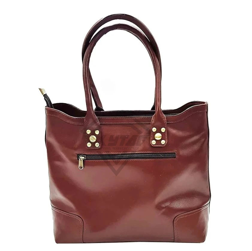 Dark maroon designer leather tote handbag with double handles, gold stud details, and an exterior zippered pocket.