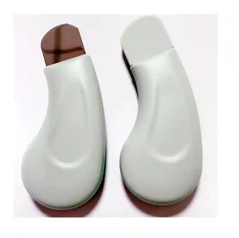 Two white, teardrop-shaped ultrasonic skin scrubbers with stainless steel spatulas for facial exfoliation and cleansing.