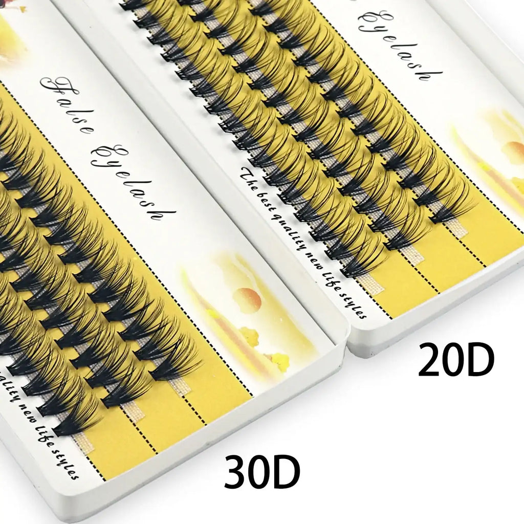 A box containing black, individual 20D and 30D cluster mink false eyelashes on a yellow background.