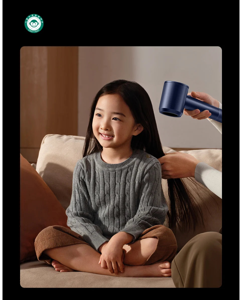 Blue MIJIA High-Speed Water Ion Hair Dryer drying a child's hair. Compact, ergonomic ionic dryer for fast, safe hair.