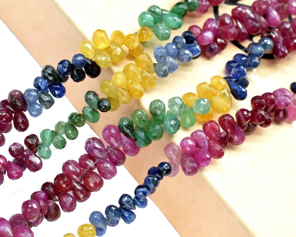 Assorted faceted drop beads (4x6mm) in pink, blue, green, and yellow on display