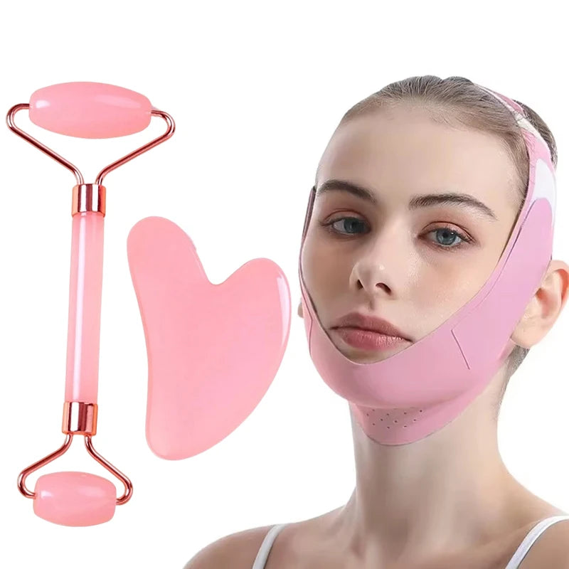 Pink V-shaped facial sculpting mask, a pink dual-ended facial roller, and a pink heart-shaped gua sha massage tool.