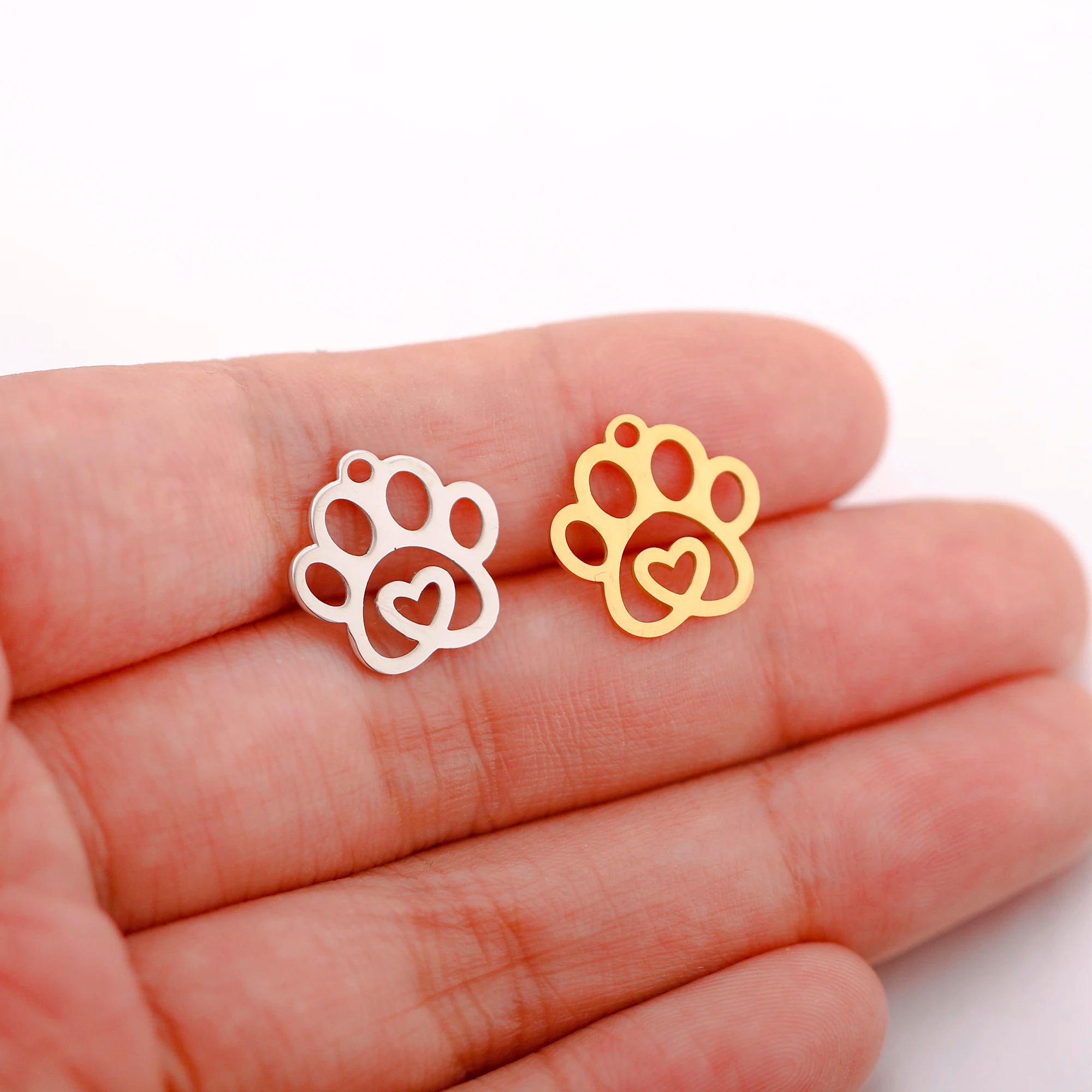 Gold and silver stainless steel paw print heart charms for DIY pet jewelry making.