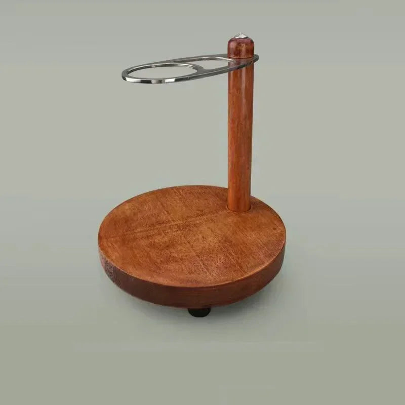 Wooden pour-over coffee dripper stand with a chrome metal ring holder on a round natural wood base.