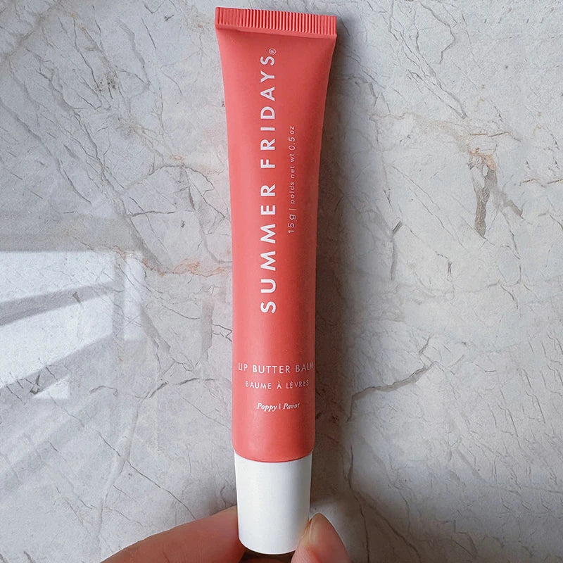 Summer Fridays Lip Butter Balm in Poppy, a moisturizing, smooth peach-toned lip balm in a soft tube.