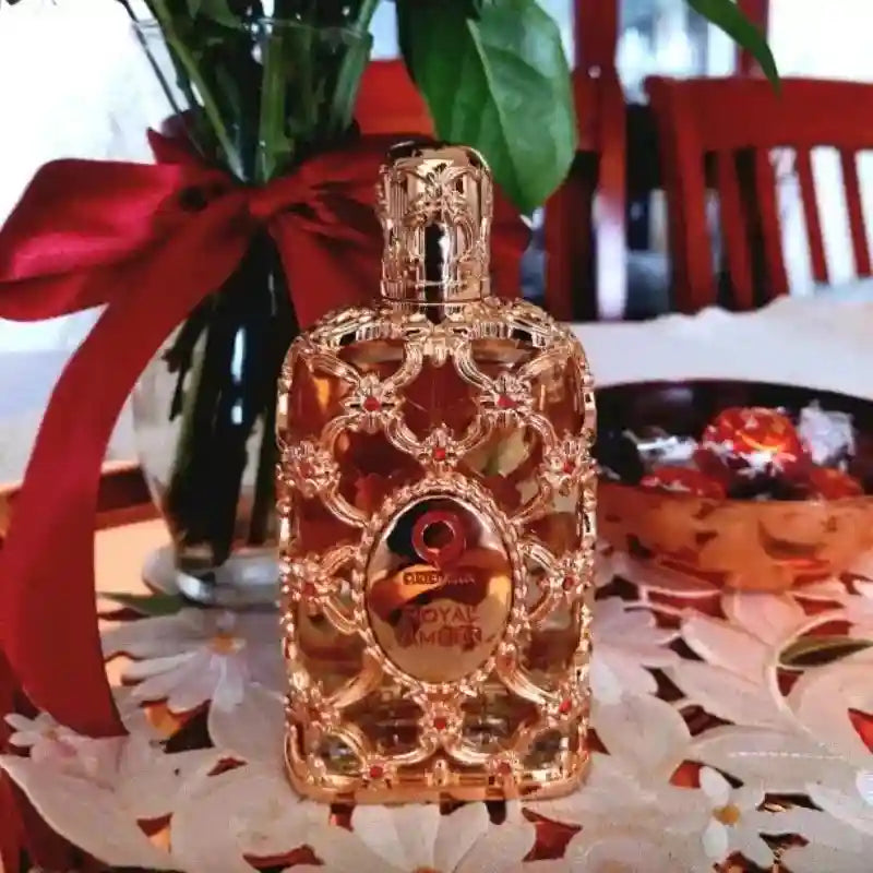 Oriento Royal Amber 100ml EDP: Luxurious unisex amber fragrance in an ornate, gold-filigree rectangular glass bottle.