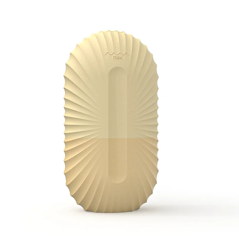 Oval cream-colored silicone ice roller mold for face with a ribbed, sunburst-patterned exterior.