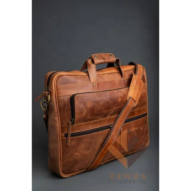Tan genuine leather business briefcase with crossbody strap, multiple zipper pockets, and top handles. Designer handbag.