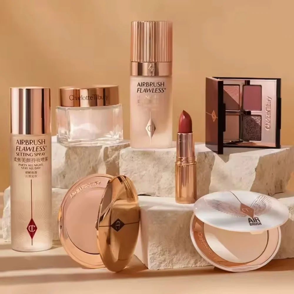 Charlotte Tilbury luxury lipstick and beauty collection in gold packaging on stone pedestals.