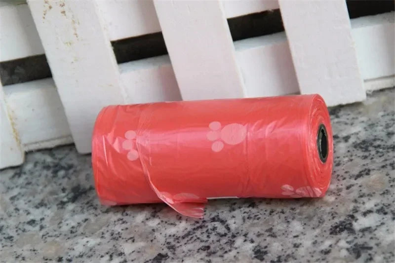 Red leak-proof dog poop bags with cute cartoon paw prints for easy, mess-free pet waste cleanup.