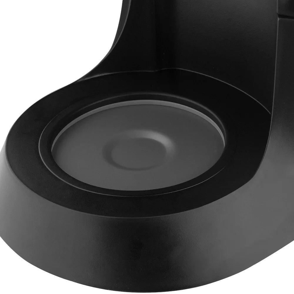 Close-up of a black matte electric coffee maker warming plate base, showing a circular heating element design.